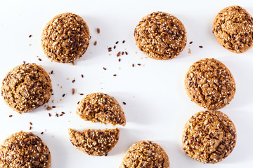 freshly baked oatmeal cookies sprinkled with sunflower seeds, linseed and sesame seeds. healthy pastries on a white background