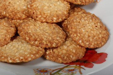 Round cookies with sesame seeds in a plate