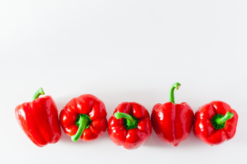 group of red ripe organic bell pepper  isolated on white. copy space