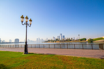 Sharjah corniche - beautiful blue sky & amazing park with full of greenery with Trident Lamppost