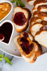 a morning breakfast with braided fresh bread, peanut butter, jam from berries and a cup of tea. healthy eating
