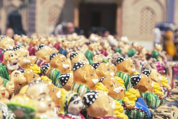 BUKHARA, UZBEKISTAN - MAY 25, 2018: Silk and Spices Festival 2018. Souvenirs shop in Bukhara, Uzbekistan. Gift Sets handmade. Miniature handmade Uzbek ceramic souvenir.