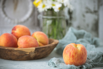 Fresh Peaches in a Wood Bowl on Soft Green Background