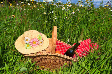 Picnic basket in summer flower field