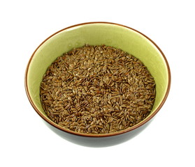 Top view of Organic Linseed or Flaxseed (Linum usitatissimum) in a bowl isolated on white background.