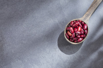 Raw red beans in the spoon - Vigna umbellata. Top view