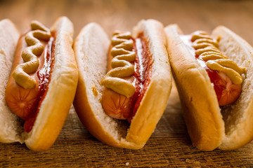 three classic hot dogs with ketchup and mustard