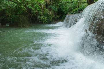 Breathtaking green waterfall at deep forest, Erawan waterfall located Kanchanaburi Province, Thailand