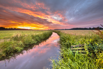 Warm indian summer sunrise over lowland river