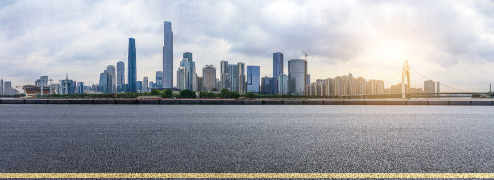 asphalt road and modern city skyline in Guangzhou at sunset,China