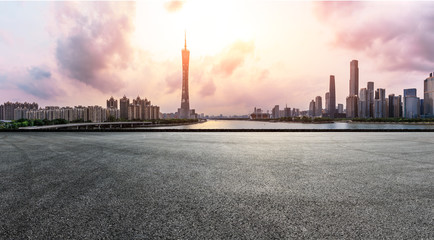 asphalt square road and modern city skyline in Guangzhou at sunset,China