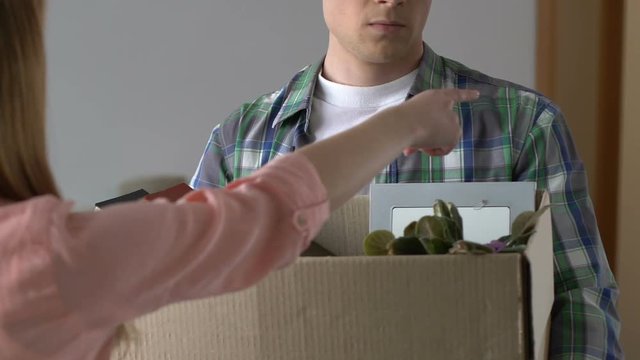 Angry woman expelling boyfriend from house, relations break up, divorce, crisis