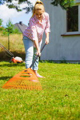 Woman using rake to clean up garden