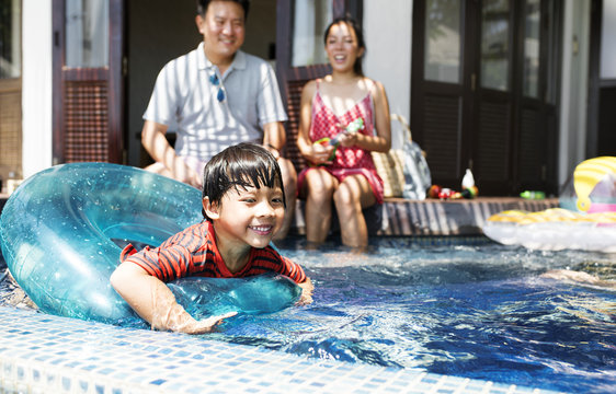 Family Playing In A Pool