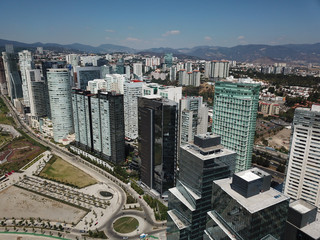 Aerial view of Santa Fe Mexico buildings and skyscrapers with mountain as background 
