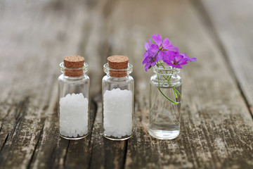 Homeopathic granules and small flowers.