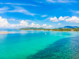 Fototapeta na wymiar Beautiful aerial view of beach and sea with many tree and white cloud on blue sky in koh samui island