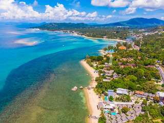 Beautiful aerial view of beach and sea with many tree and white cloud on blue sky in koh samui island