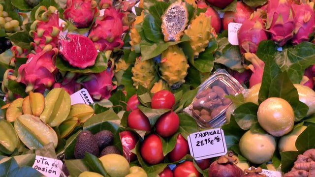 La Boqueria market - The famous fruit stand with a stunning display of products. La Boqueria is a large public market and one of the city's foremost tourist landmarks