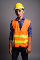 Young Indian man construction worker wearing protective glasses 