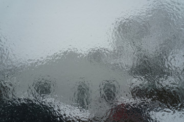 Surface of window after winter storm covered with sheet of ice