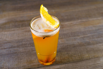 Hot spicy apple cider with cinnamon and orange slices. Warming autumn beverage, cozy mood, holiday drink, party and bar concept