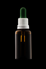 Herbal medicine or aromatherapy dropper bottle isolated on black background