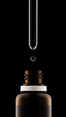 Herbal medicine or aromatherapy dropper bottle isolated on black background