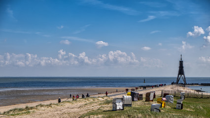 Sandy beach under vivid blue sky on a warm and sunny day in Cuxhaven - obrazy, fototapety, plakaty