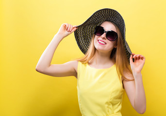 Happy young woman wearing a summer hat