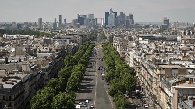Elevated view from the top of the Arch de'Triomphe along the Ave de La Grande Armee towards the financial and business district of La Defense, Paris, France - T/lapse