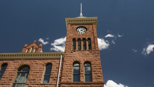 Time lapse of a old courthouse clock tower and moving clouds
