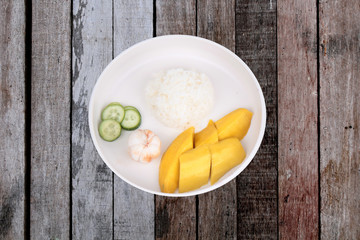 Thai treaditional food, Jasmine rice with vegetables and fruits as mangosteen, mango and cucumber.
