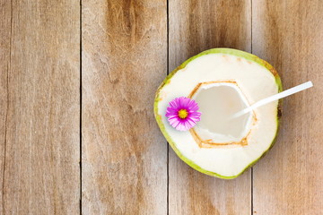 Coconut juice on wooden table with space for text.Top view