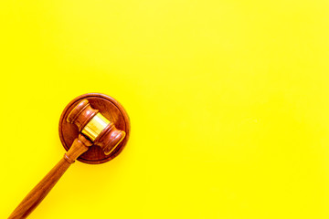 Obraz premium Lawyer or attorney concept. Judge gavel on yellow background top view copy space