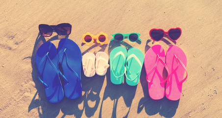 Colorful sandals on the sand at the beach