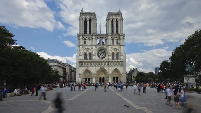 Notre Dame Cathedral a famous Landmark in the center of Paris with many tourists visiting, France, Europe, T/Lapse