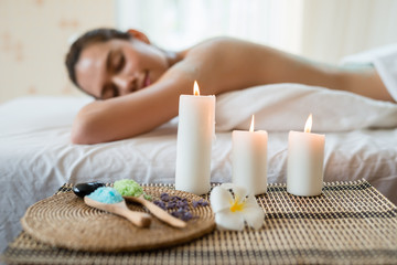 candle on a mat. background Young beautiful Asian woman relaxing in the spa massage