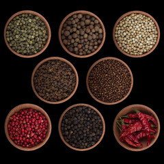 set of peppercorn in wooden cup isolated on black background