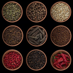set of peppercorn in wooden cup isolated on black background
