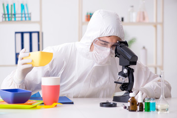 Chemist checking and testing plastic dishes