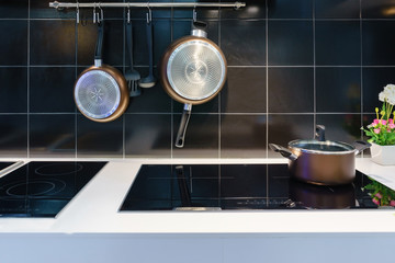 Metal Pot on induction hob in modern kitchen. modern kitchen pot cooking induction electrical stove...
