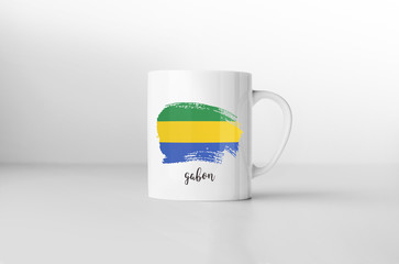 Gabon flag souvenir mug on white background. 3D rendering.