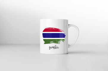 Gambia flag souvenir mug on white background. 3D rendering.