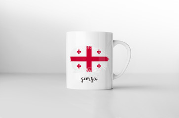 Georgia flag souvenir mug on white background. 3D rendering.