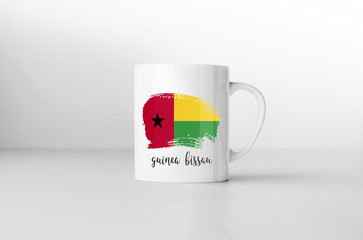 Guinea-Bissau flag souvenir mug on white background. 3D renderin