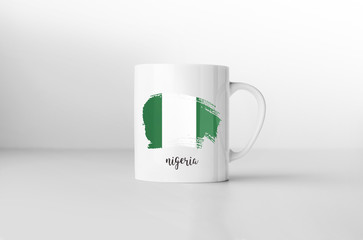 Silky flag of Nigeria flag souvenir mug on white background. 3D