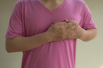 Man holding breast because of heart infarction.
