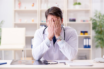 Young doctor sitting in the office