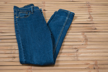 Blue jeans on wood background.